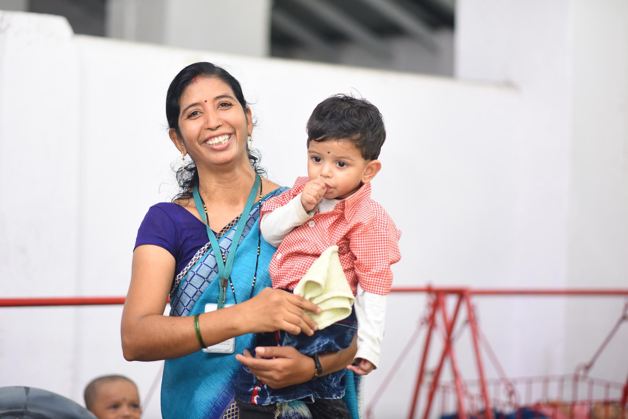 Teacher caring for a child at Antarbharti Ashram